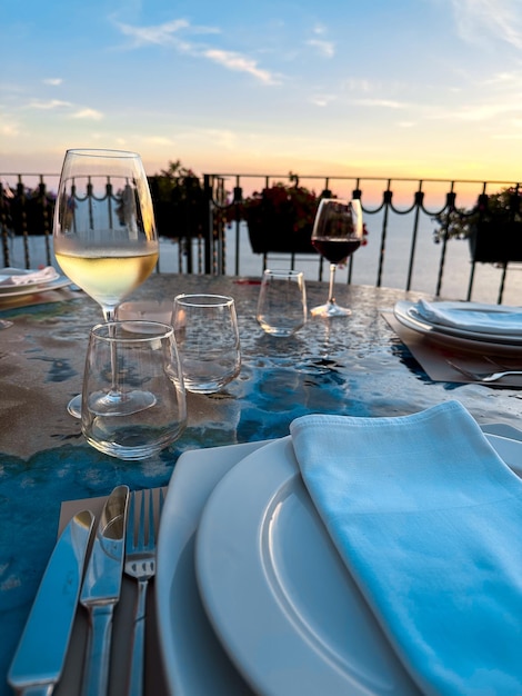 Glass of wine in the landscape with dramatic sky during sunset