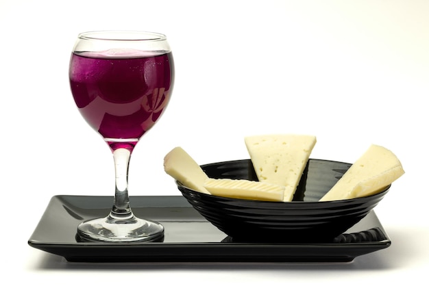 Glass of wine with a plate of cheese.