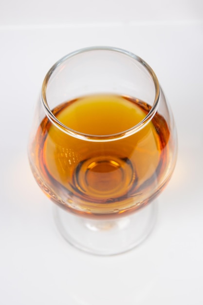 Glass with cognac on a white background