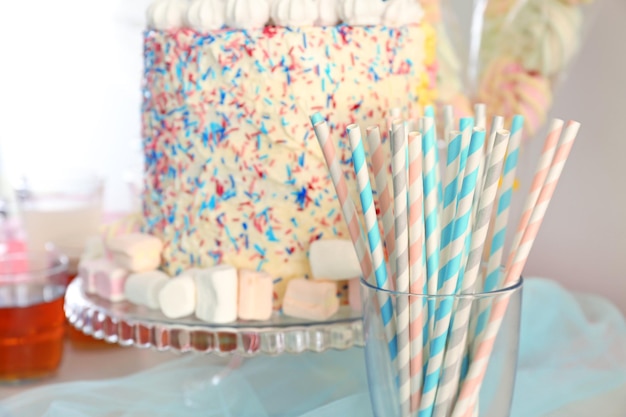 Glass with colorful straws on buffet table