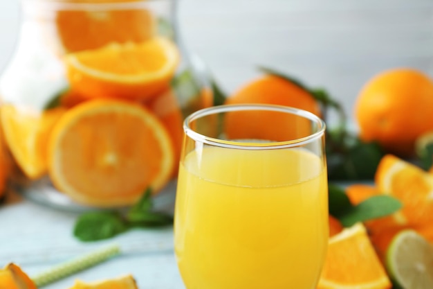 Glass with delicious orange juice on blurred background