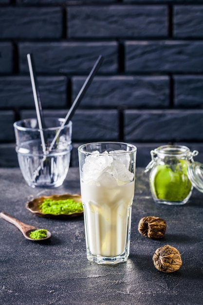 A glass with ice cubes and milk