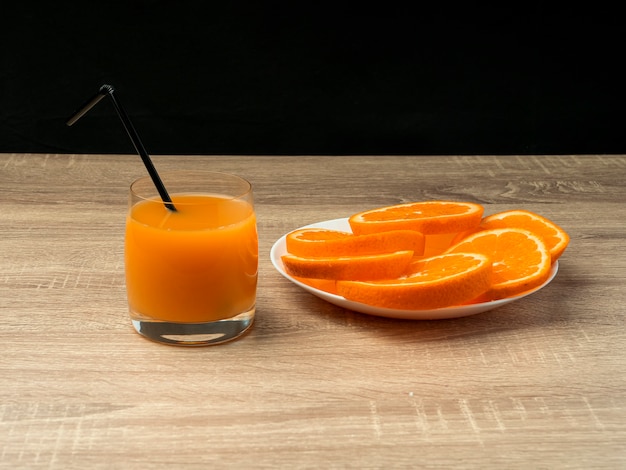 Glass with orange juice and orange