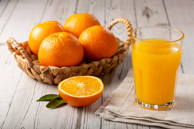 Glass with orange juice on the table.