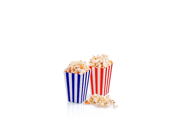 Glass with popcorn on a white background closeup