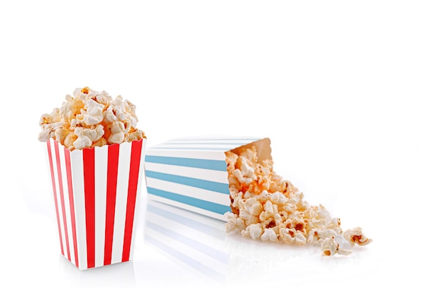 Glass with popcorn on a white background