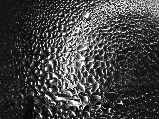 Glass with raindrops on a dark background