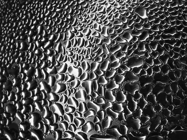 Glass with raindrops on a dark background