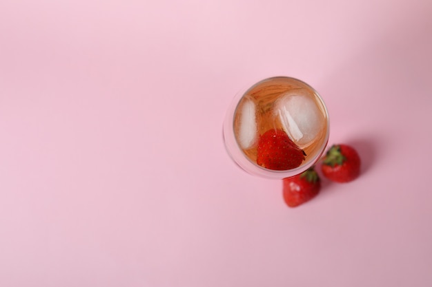 Glass with Rossini cocktail on pink background