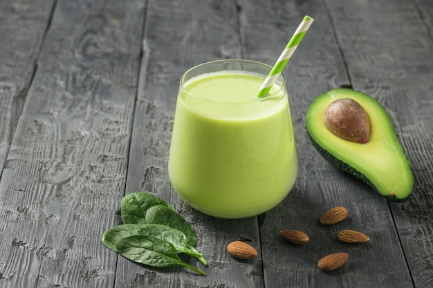 A glass with a smoothie made from almond milk, avocado and spinach. Fitness product. Dietary sports nutrition.