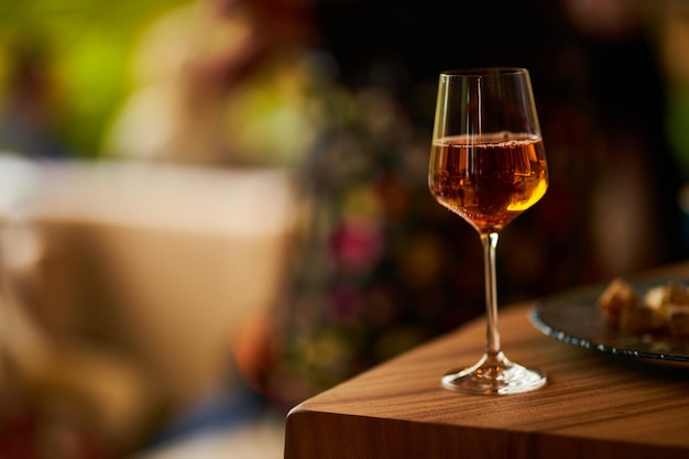 glass with white wine on the edge of the table closeup white wine in a glass on the table