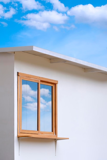 Glass and wooden window of white mini street coffee kiosk outside of shopping mall with blue sky