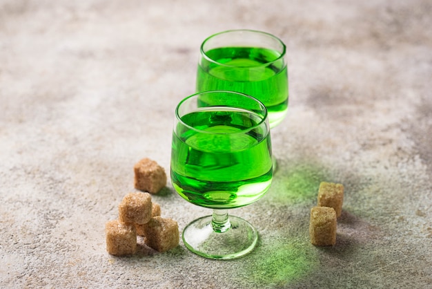 Glasses of absinthe with brown sugar 