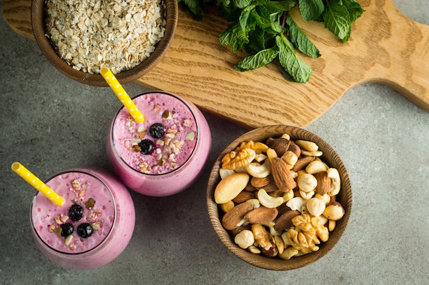 Glasses of berry smoothie with nuts. 