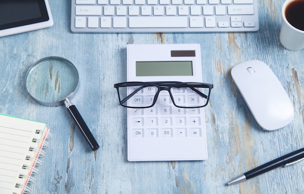 Glasses on the calculator. Office modern workplace. Business concept