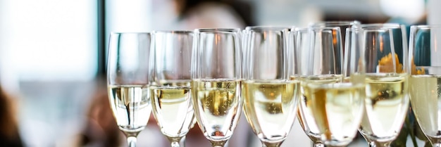 Glasses of champagne and sparkling wine served at charity event alcoholic drinks