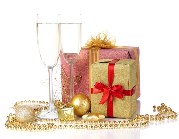 Glasses of champagne with gift boxes isolated on white