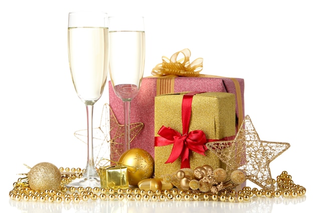 Glasses of champagne with gift boxes isolated on white