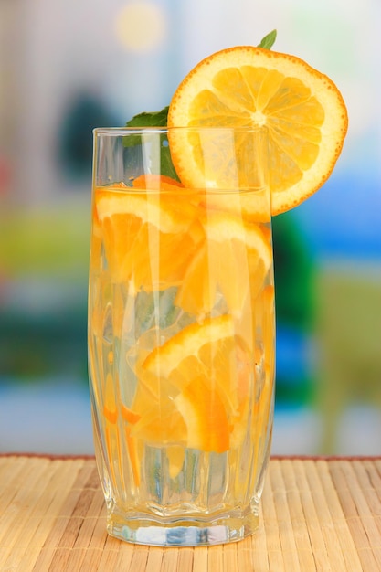 Glasses of fruit drinks with ice cubes on table in cafe