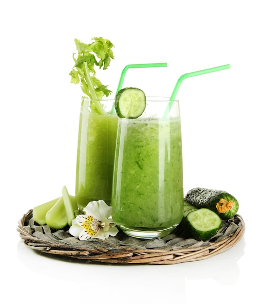 Glasses of green vegetable juice isolated on white