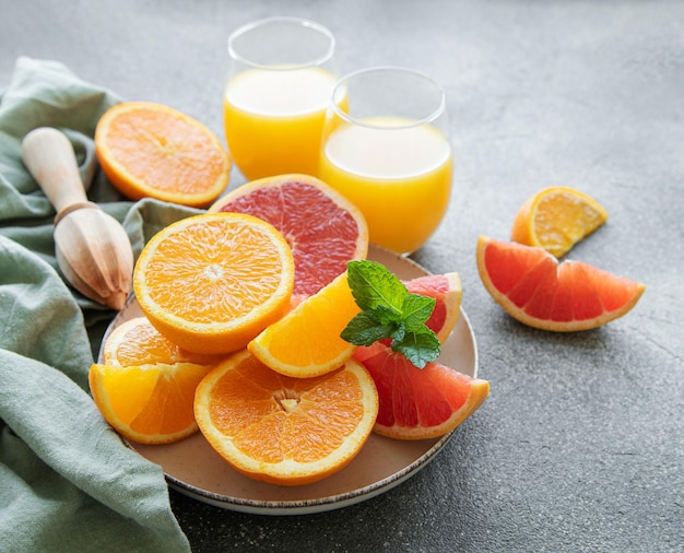 Glasses of juice and citrus fruits