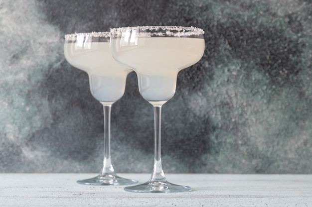 Glasses of Margarita cocktail garnished with salt rim