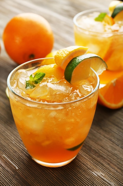 Glasses of orange juice on wooden table closeup