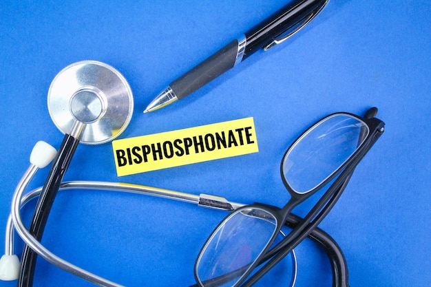 glasses, pen and stethoscope with the word bisphosphonate