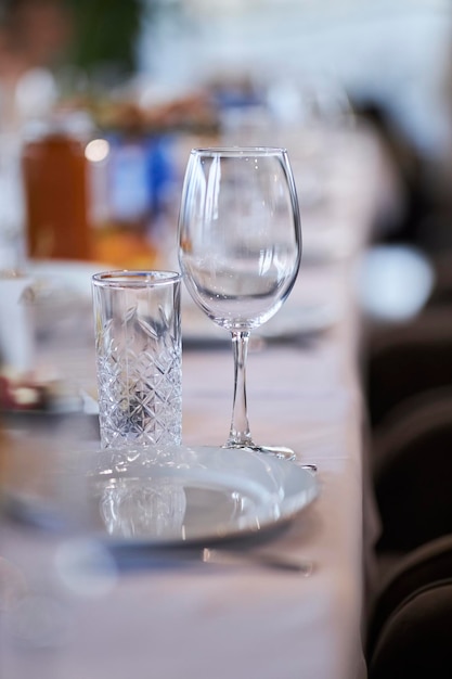 glasses on a served table with a white tablecloth setting glasses on a served table