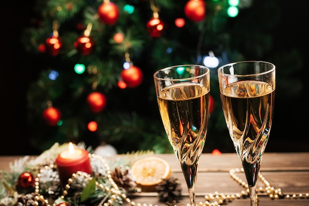 Glasses of sparkling champagne on the background of a decorated Christmas tree. New year mood