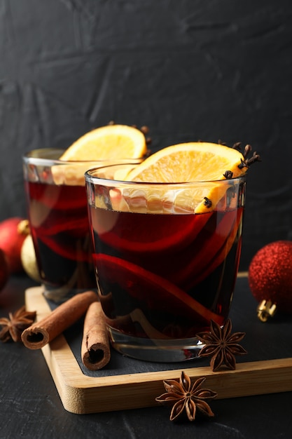 Glasses of tasty mulled wine and christmas baubles