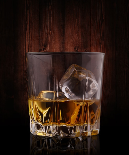 Glasses of whiskey with ice cubes