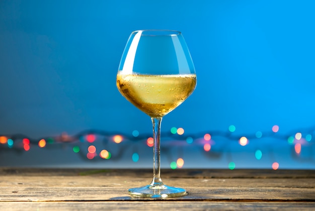 Glasses of white wine on wooden table 