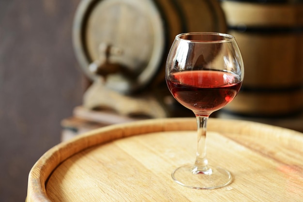 Glasses of wine in cellar with old barrels