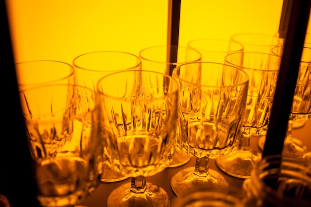 Glasses for wine in different colors Multicolored glasses on the bar in the restaurant night life