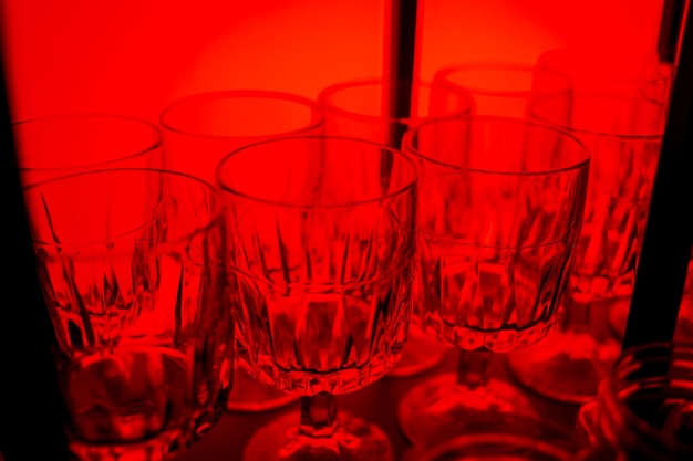 Glasses for wine in different colors Multicolored glasses on the bar in the restaurant night life