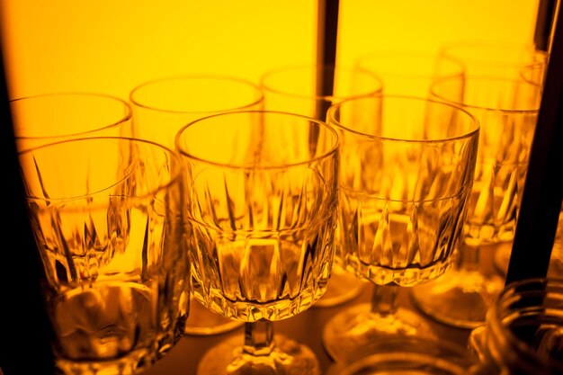 Glasses for wine in different colors Multicolored glasses on the bar in the restaurant night life