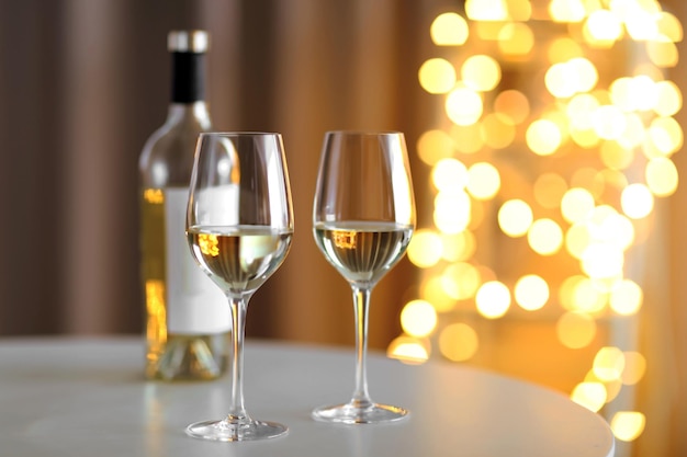 Glasses of wine on romantic blurred background