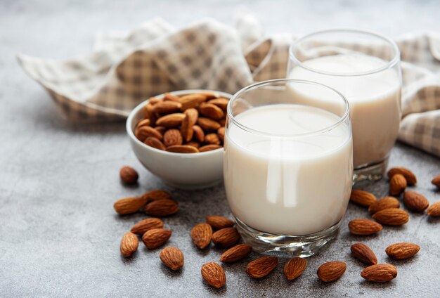 Glasses with almond milk and almonds on the table