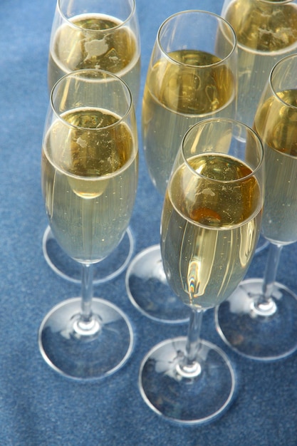 Glasses with champagne on shiny background