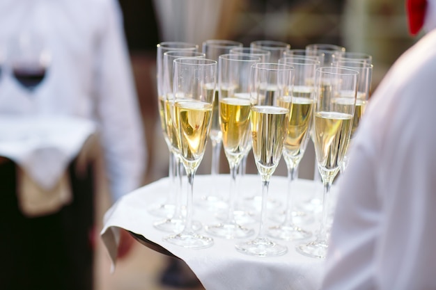 Glasses with champagne on a tray. Meeting the guests.