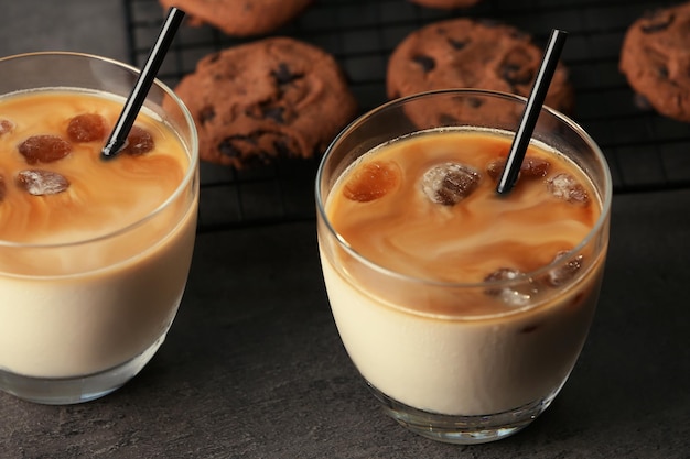 Glasses with delicious iced coffee on table