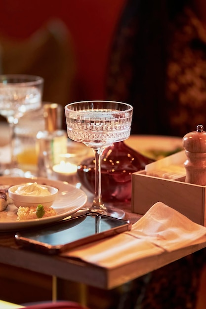 Glasses with drinks in a dimly lit restaurant