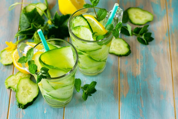 Glasses with fresh organic Cold and refreshing infused detox water and cucumber Copy space