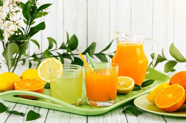 Glasses with lemonade and orange juice