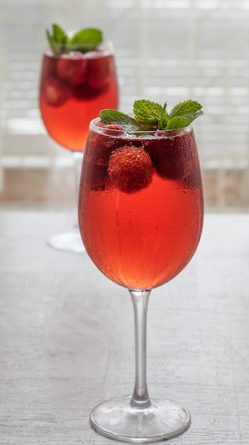 Glasses with a refreshing drink with strawberries and mint. 