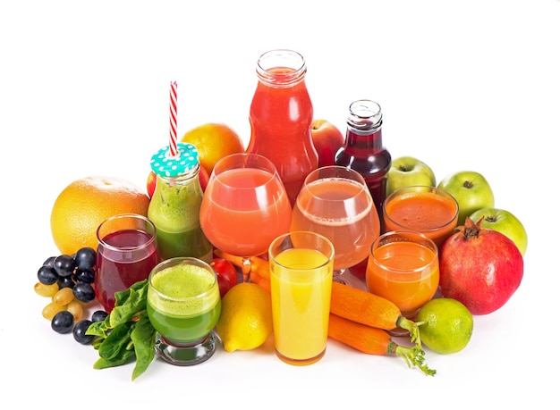 Glasses with various fresh vegetable juices on white surface