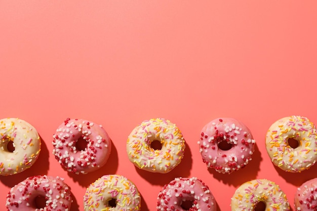 Glazed donuts on pink background space for text