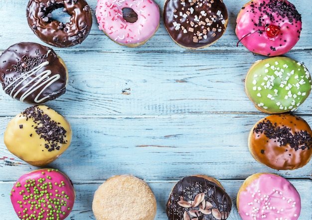 Glazed donuts with different fillings on a blue