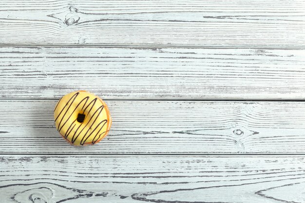 Glazed donuts on wooden surface